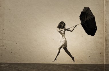 Young girl with umbrella. Photo in old color image style. clipart