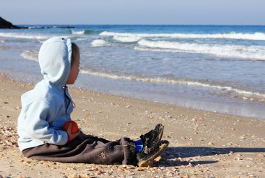 4 years old boy looking at the seaside clipart