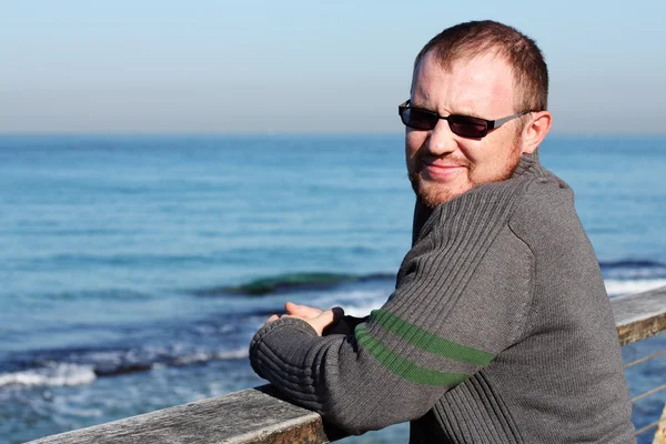 Schöner 35-jähriger Mann im Hintergrund des Meeres — Stockfoto