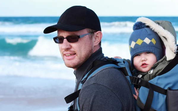 Vader met klein kind op een strand winter wandelen. — Stockfoto