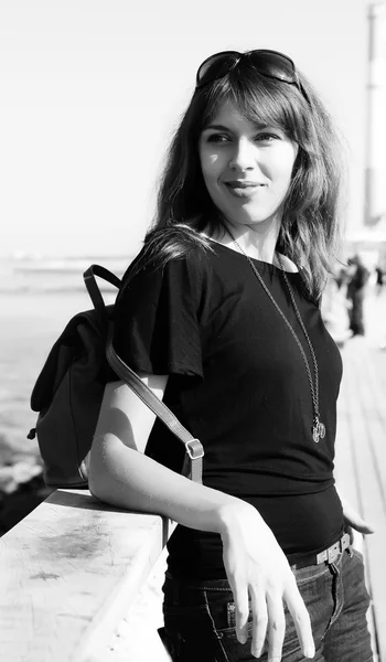 Beautiful young girl on the seafront. black and white photograph — Stock Photo, Image