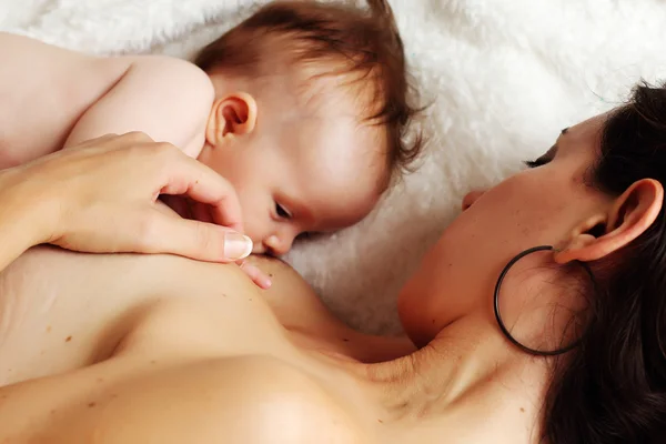Mother feeding baby soft focus — Stock Photo, Image