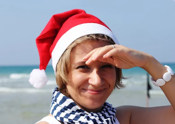 Jul på havet. flicka i Tomtemössa på stranden. — Stockfoto