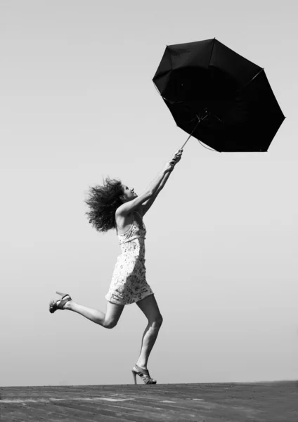 Young girl is fighting with wind — Stock Photo, Image