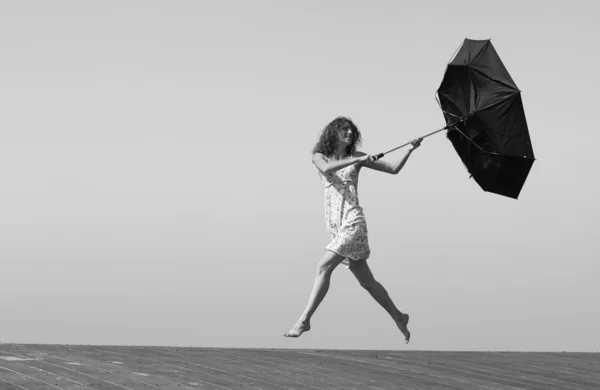 Young girl is fighting with wind — Stock Photo, Image