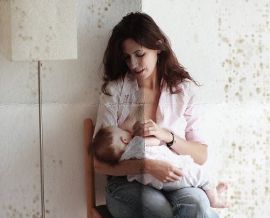 Mother breast feeding her baby. Photo in old color image style. clipart