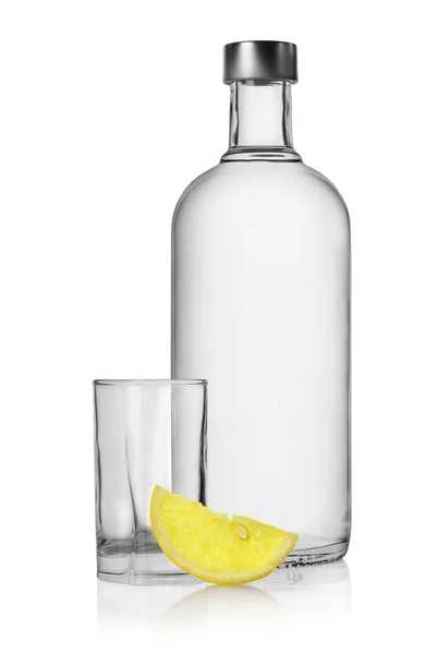 stock image Bottle of vodka and lemon isolated