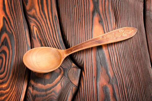 Wooden spoon on the wooden background — Stock Photo, Image