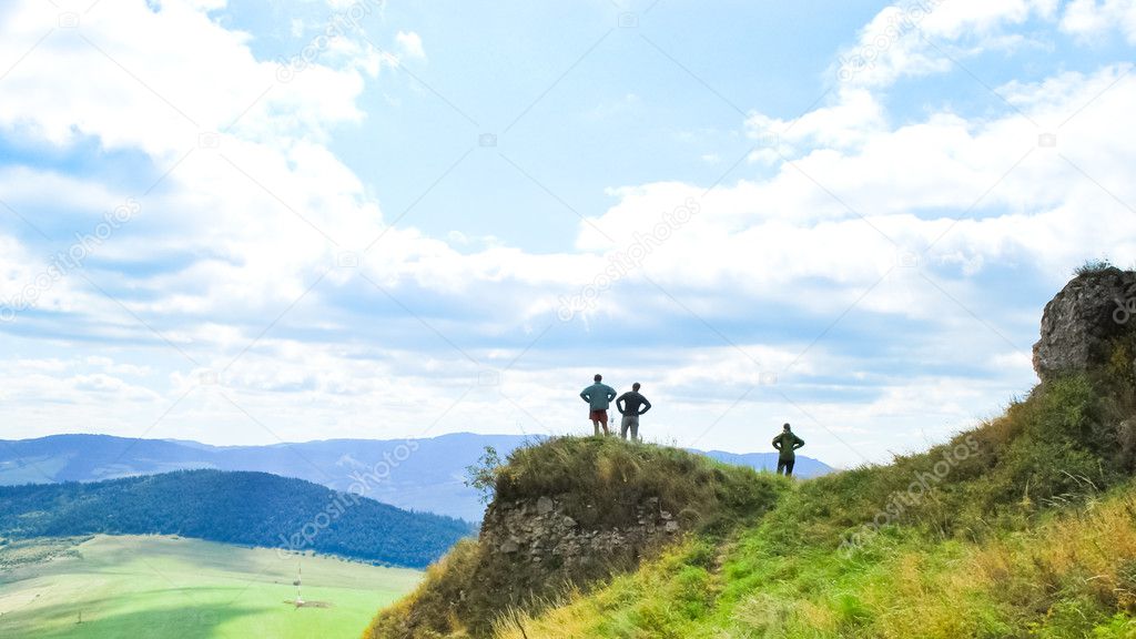 Three tourists on viewpoint