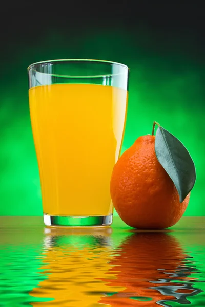 Orange juice in a glass on a table — Stock Photo, Image
