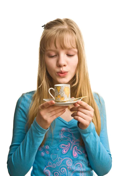 Blonde girl blow to cup of tea — Stock Photo, Image