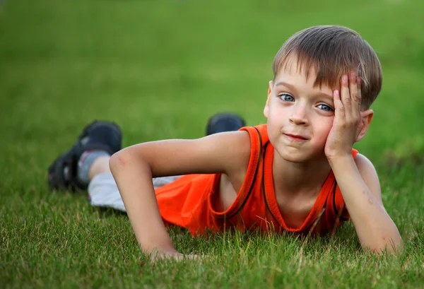 Little boy laying on the grass — Stock Photo, Image