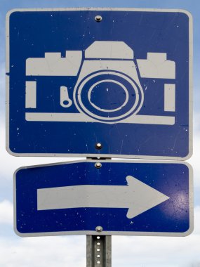 Point of interest road sign with white camera icon clipart