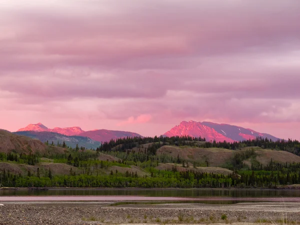Distantes montanhas Yukon brilhando na luz do pôr do sol — Fotografia de Stock