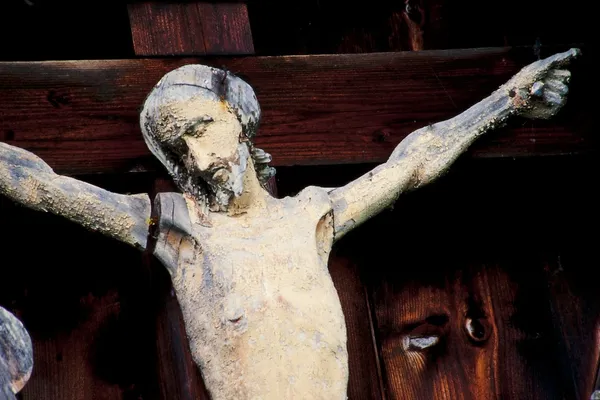 stock image Weathered Jesus Christ figure nailed to the cross