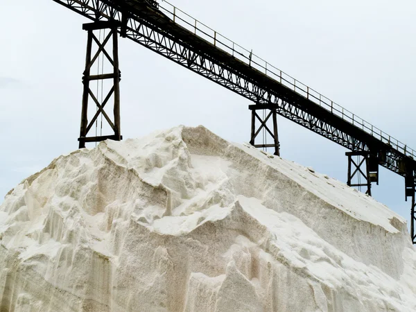 stock image Pile of sea salt under conveyor of saline refinery