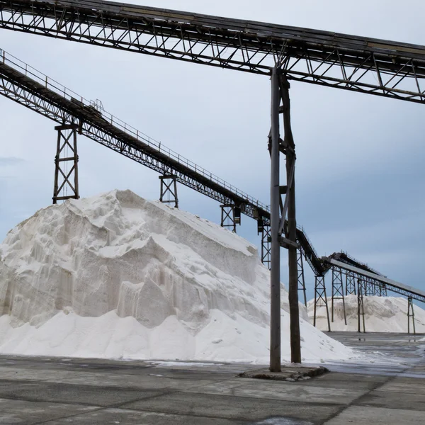 Stock image Pile of sea salt under conveyor of saline refinery