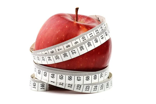 Červené jablko a měr páska — Stock fotografie