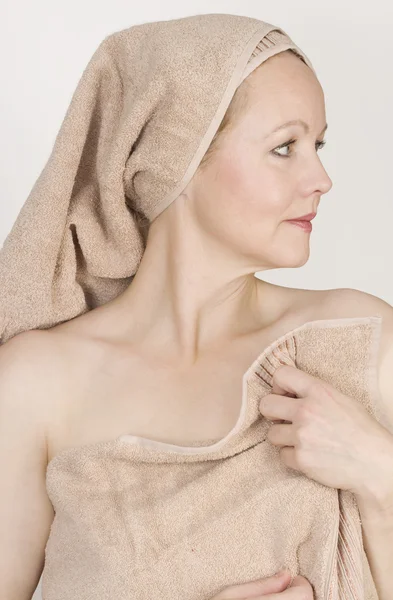 Adult beautiful woman after bath with a towel on her head. — Stock Photo, Image
