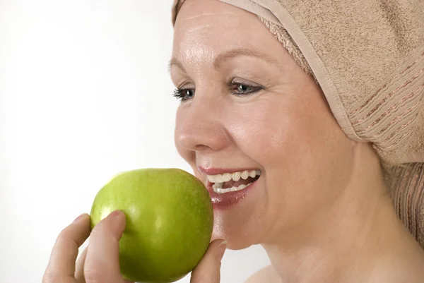 Adult woman biting an apple. — Stock Photo, Image