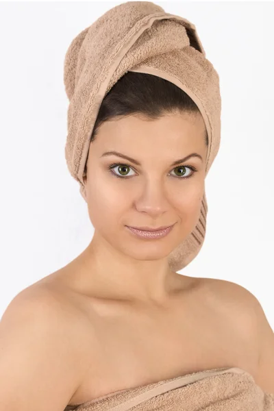 Beautiful young woman with a towel on her head. — Stock Photo, Image