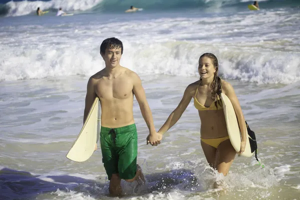 Pareja joven surfeando en hawaii — Foto de Stock