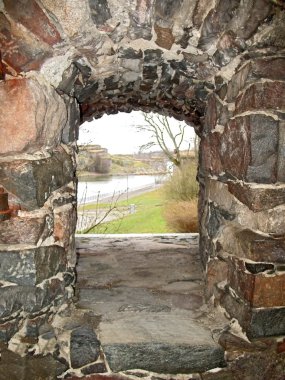 View through stone window in the wall of castle. clipart