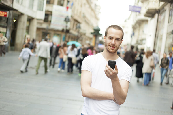Man joy with cell phone in city