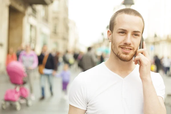 Young Man talking with cell phone walking — Stock Photo, Image