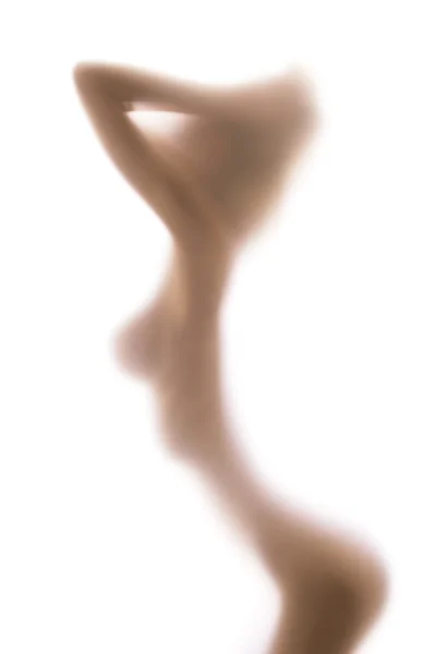 stock image Blurred glass hiding sexy female figure, hands on head, big brea