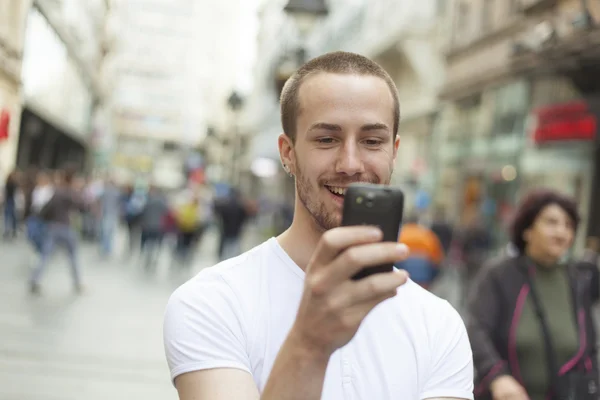Young Man with cell phone walking Stock Photo