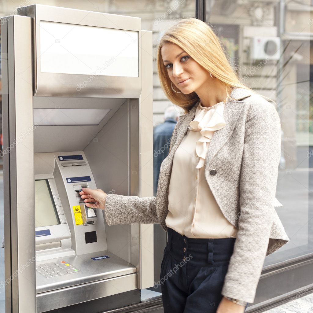 Woman using Bank ATM machine