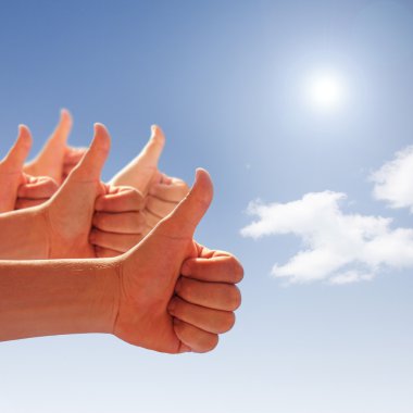 Thumbs up on background of blue sky and white clouds clipart