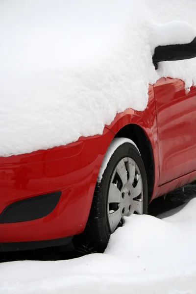 Red car covered with snow in winter — Stok fotoğraf