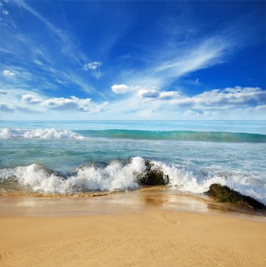 Stones in the waves on ocean coast clipart