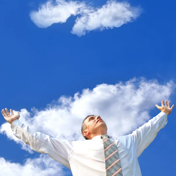 Businessman over blue sky background — Stock Photo, Image