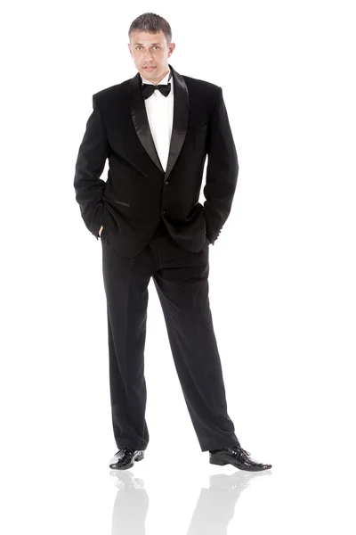 The elegant man in a classical tuxedo on a white background — Stock Photo, Image