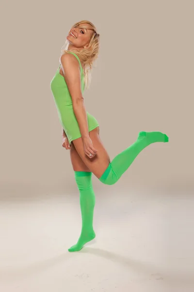 Bright green long stockings on a pretty girl — Stock Photo, Image
