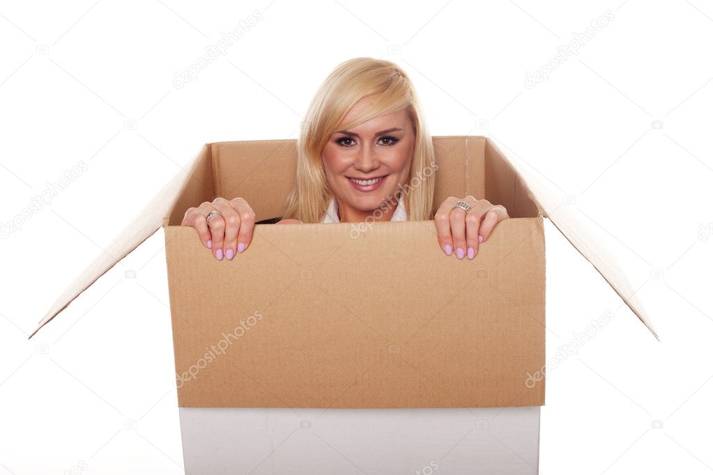 Attractive young blonde emerging from a box