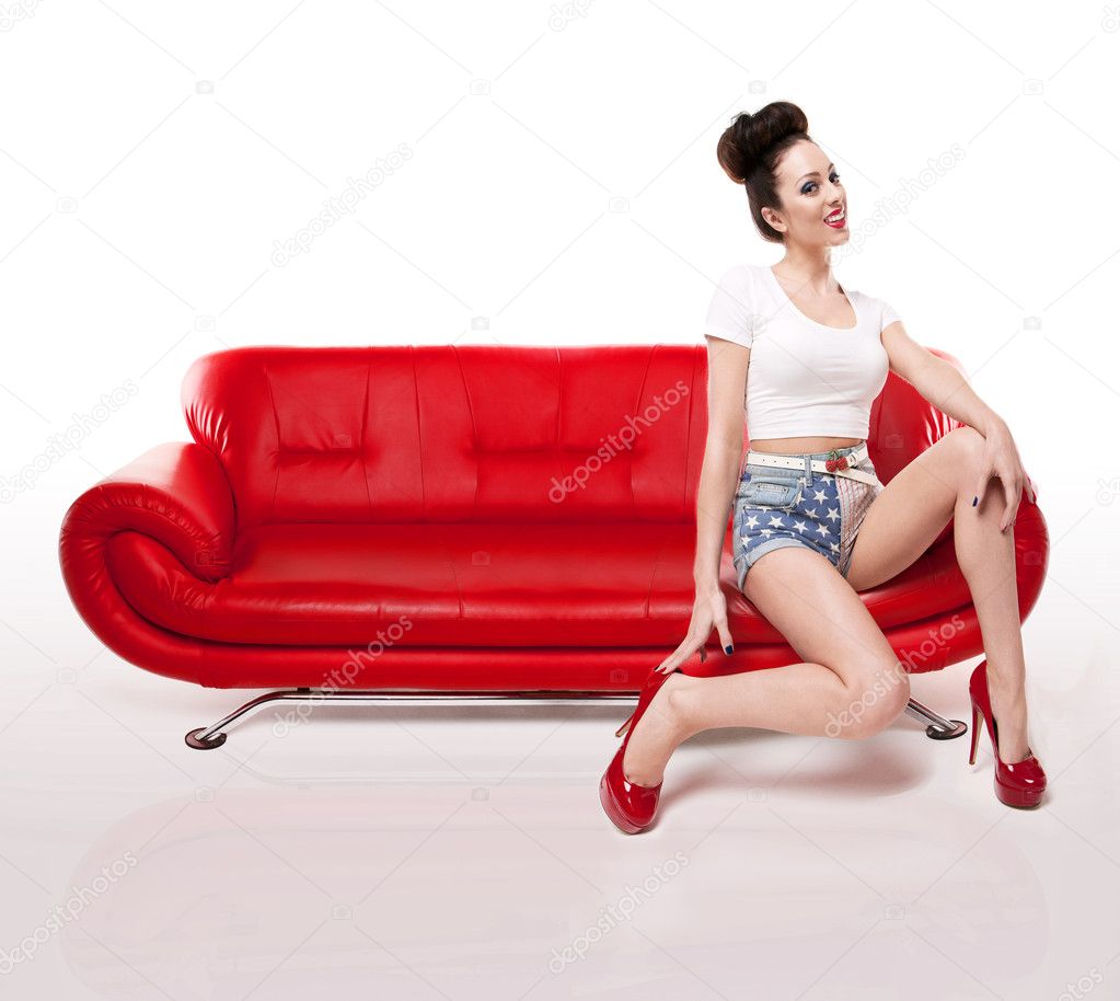 Retro Pin-up Girl On Red Leather Couch