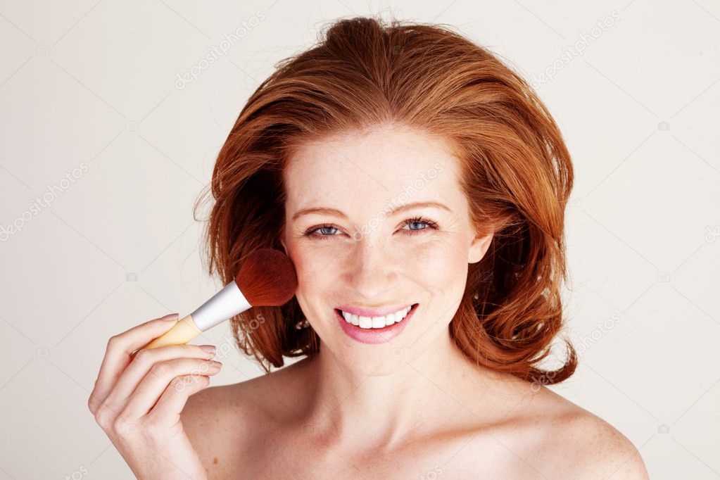 Smiling Woman Applying Blusher