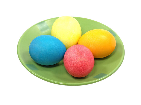 Multicolored eggs on a green plate.Isolated.