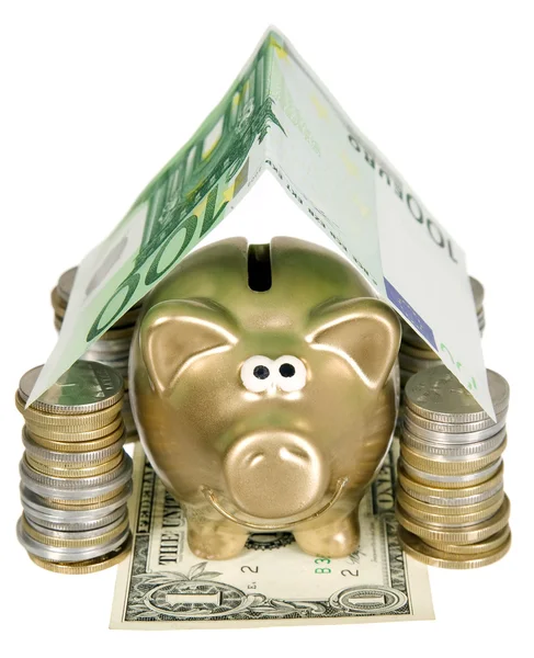 A golden moneybank under house made from banknote — Stock Photo, Image