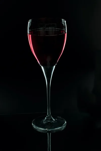 stock image Glass of wine on a black background