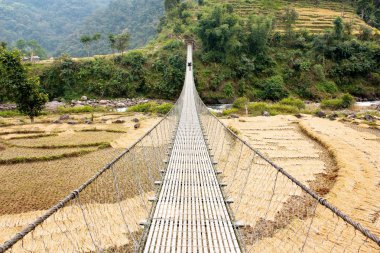 Hanging footbridge in Nepal clipart