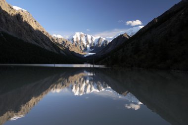 View of masej lake and valley and rock face - altai mountains russia clipart