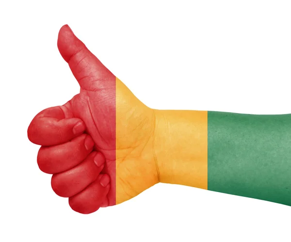 Guineas flagga på tummen upp gest som ikon — Stockfoto