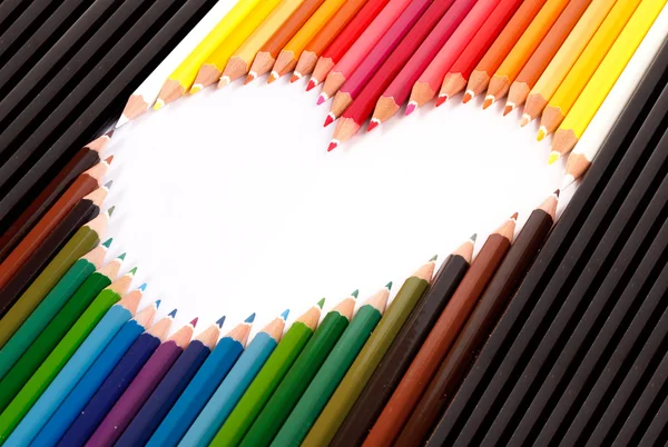 Colorful pastel pencil arrange in heart shape — Stock Photo, Image