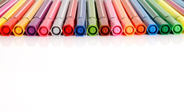 Plastic colorful pens in row clipart