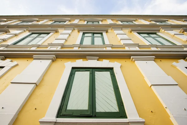 stock image Ancient yellow building with green wooden window in Bangkok